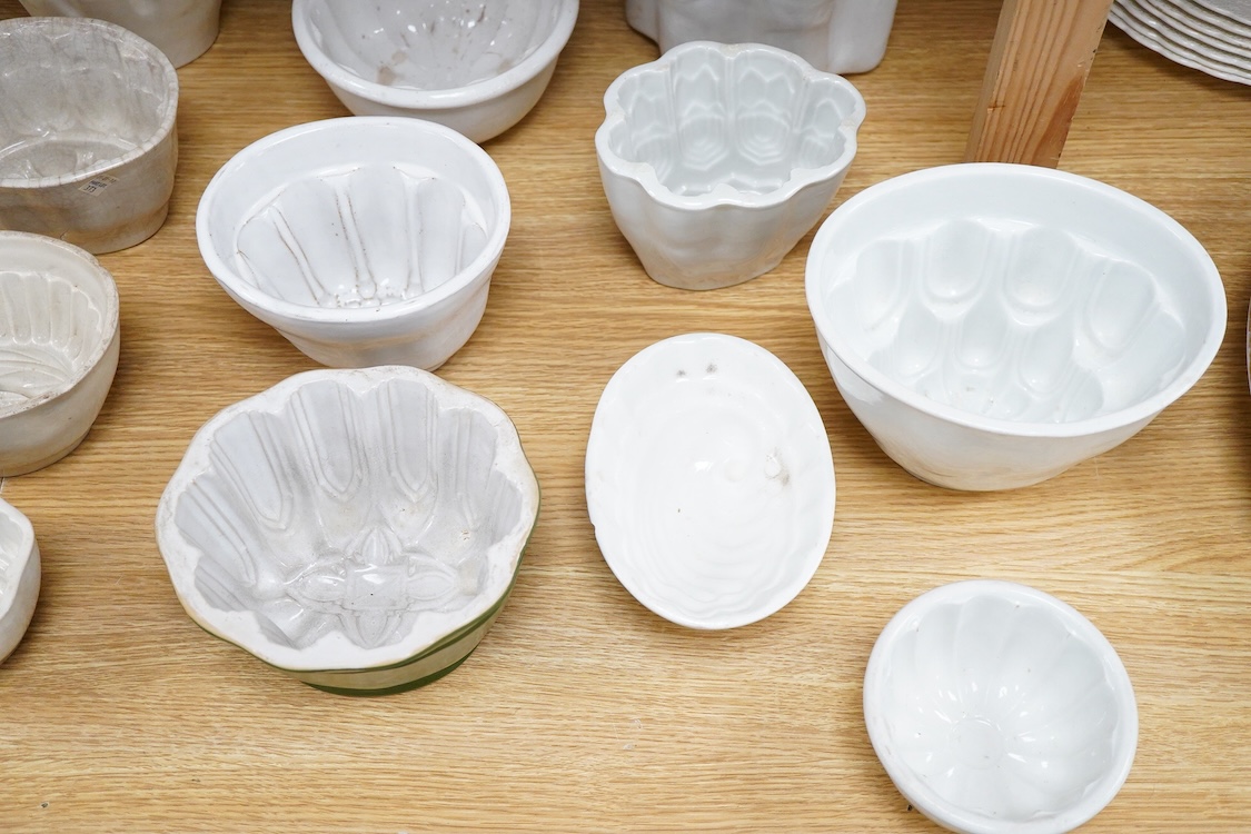 A collection of fifteen mostly 20th century ceramic jelly moulds, largest 16cm high